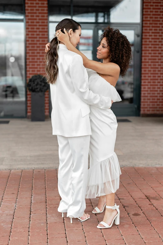 two women hugging and posing for a pograph