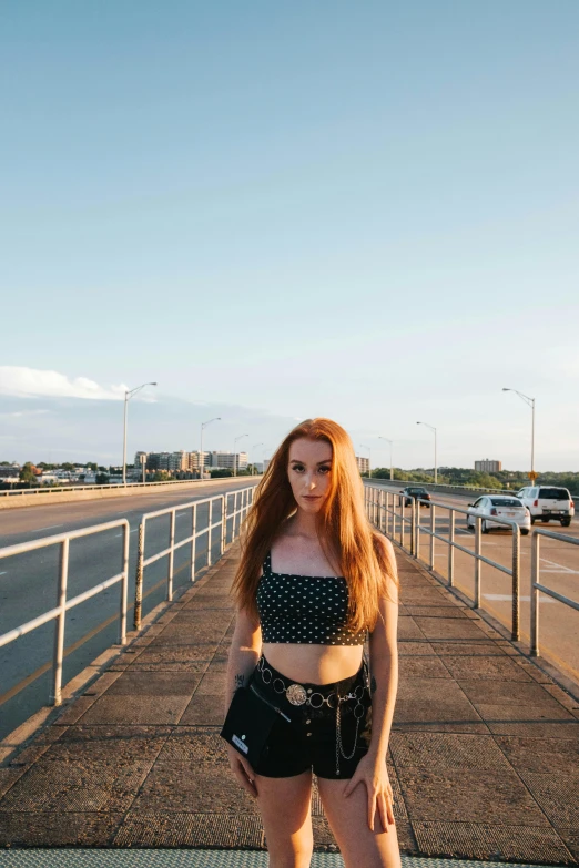 a young woman posing on the edge of a walkway