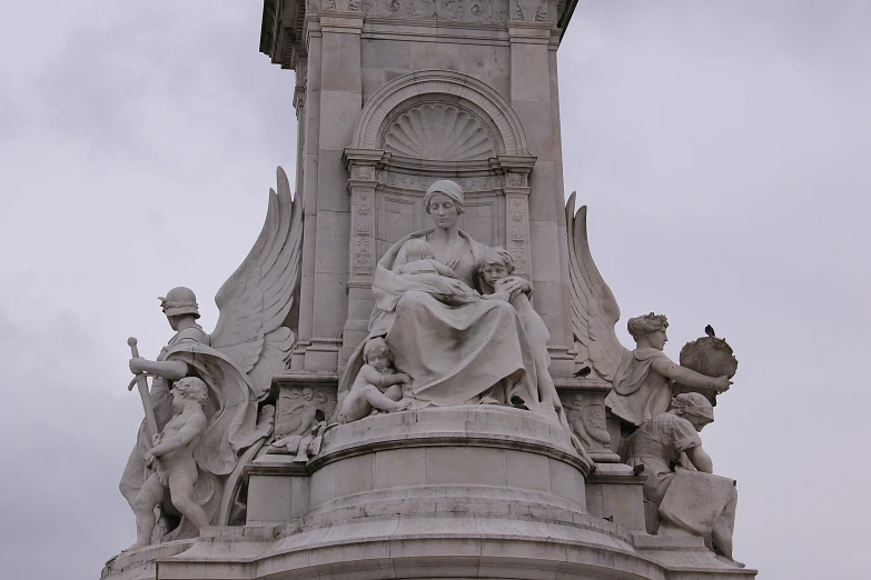 an antique statue and a clock on top of a building