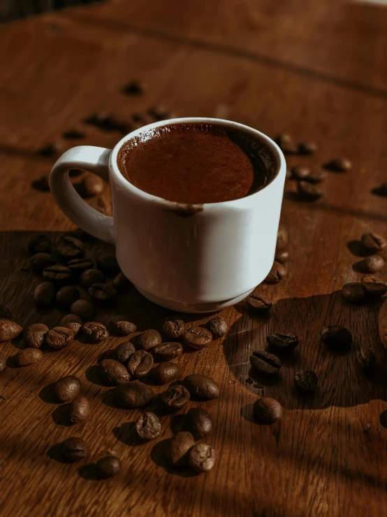 a mug of  chocolate and coffee beans