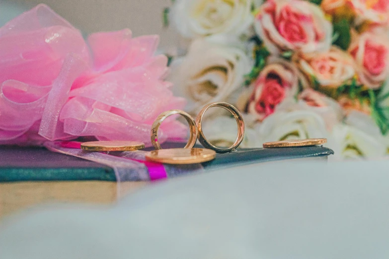 a phone with ring on it and some flowers