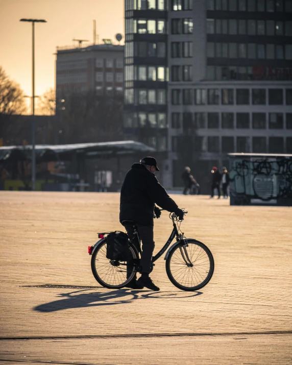 a person is standing next to their bike in the street