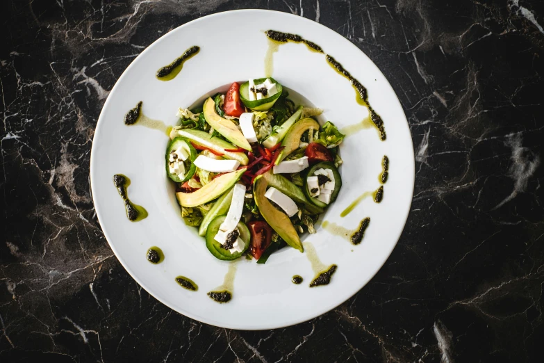 this plate has been tossed with pest and an assortment of vegetables