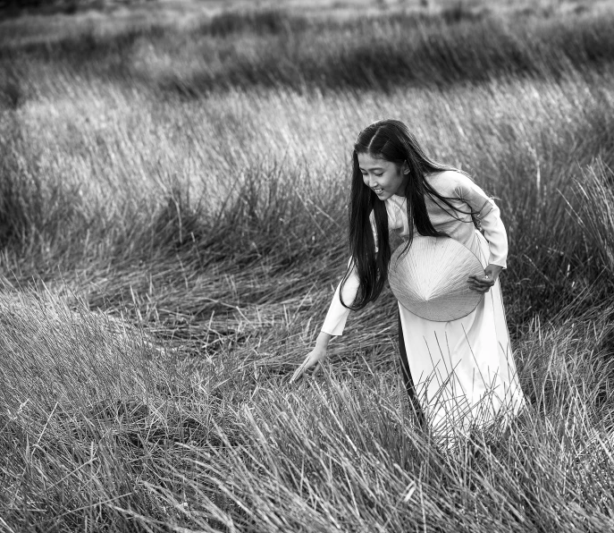 a pregnant woman in a field in the rain