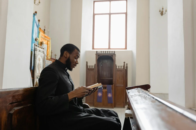 a man in a large church looking at his cell phone