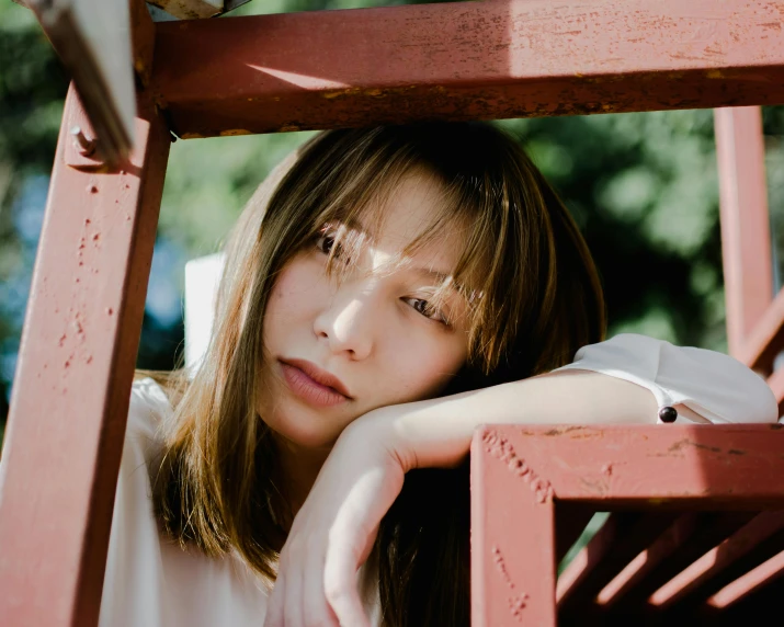 an asian woman with short hair sitting in a chair