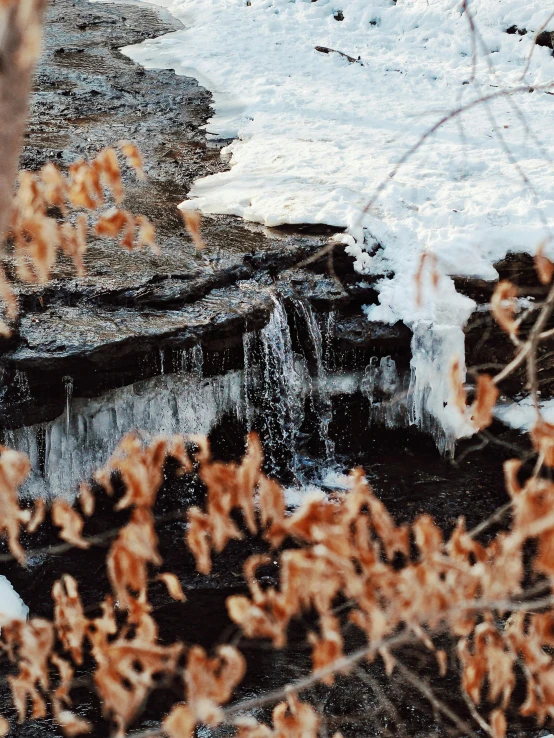 an open water fall with ice hanging over the top