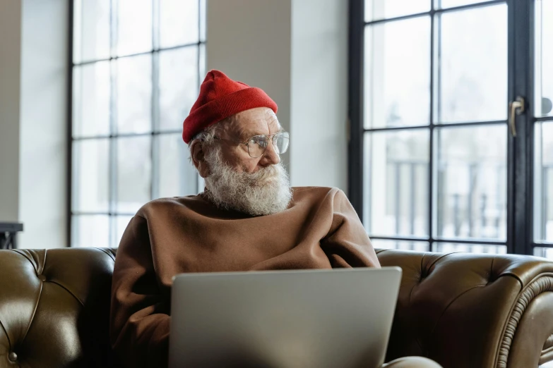 a man in a red hat and a laptop