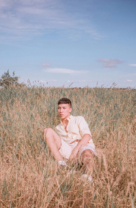 a man is posing for a po in a field