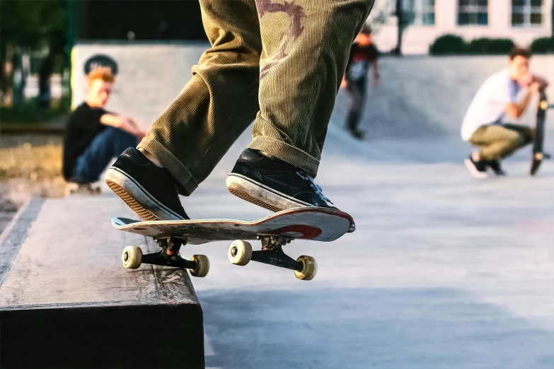 a  does tricks on his skate board while others watch