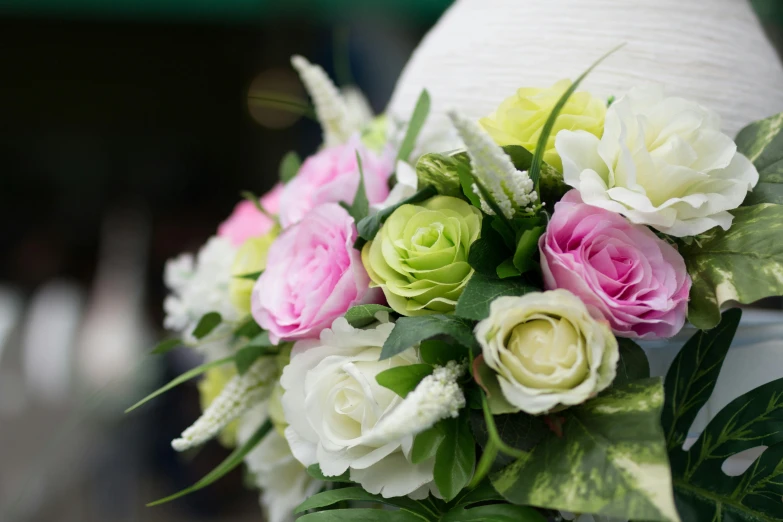 wedding bouquet in front of a dress on display