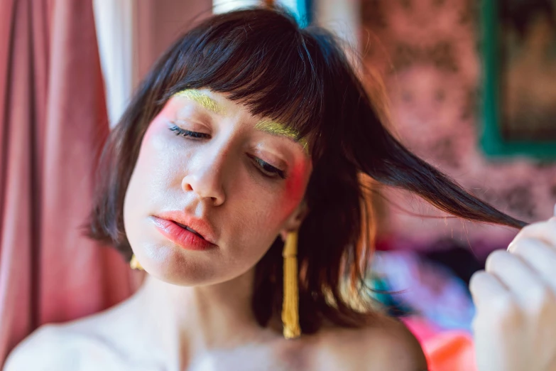 a woman with bright makeup posing for the camera