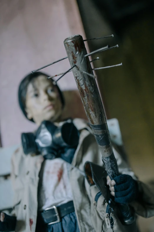 a little boy in a soldier's outfit holding onto a large walking stick