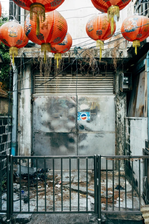 chinese lanterns hang in front of an urban building