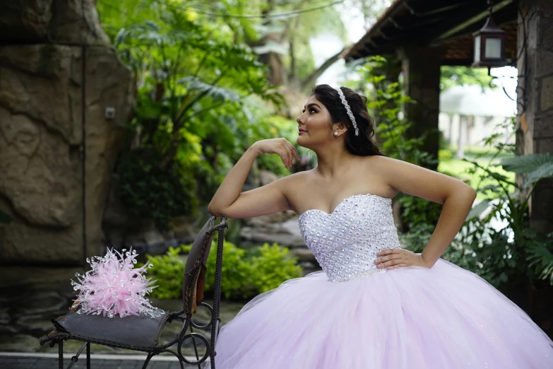 a woman standing next to a bench wearing a dress