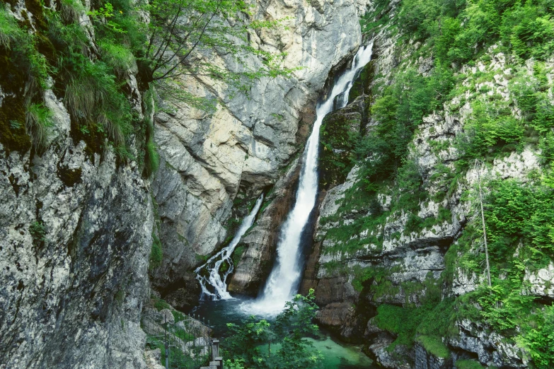 a small waterfall cascades down into a body of water