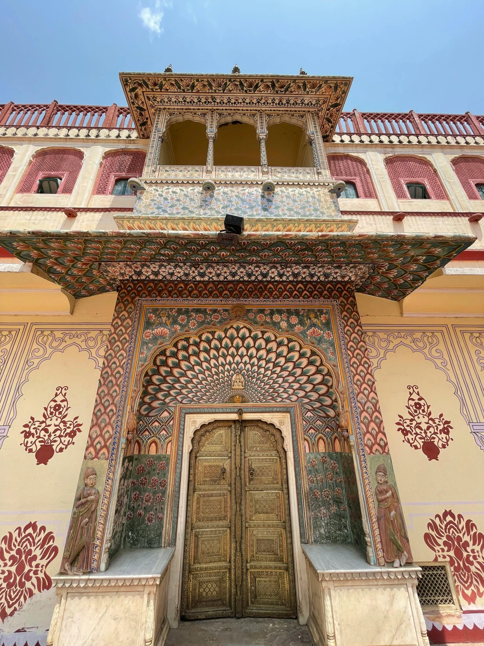 an ornate building with a golden door and red, white and blue patterns