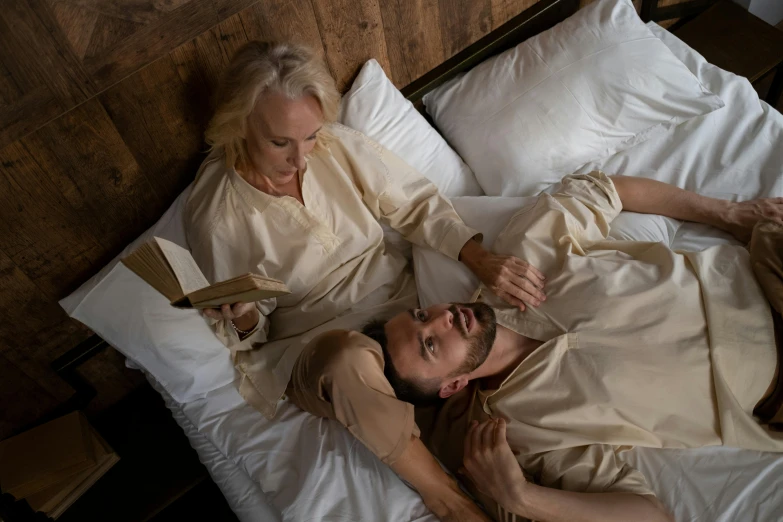 a man and a woman laying in bed