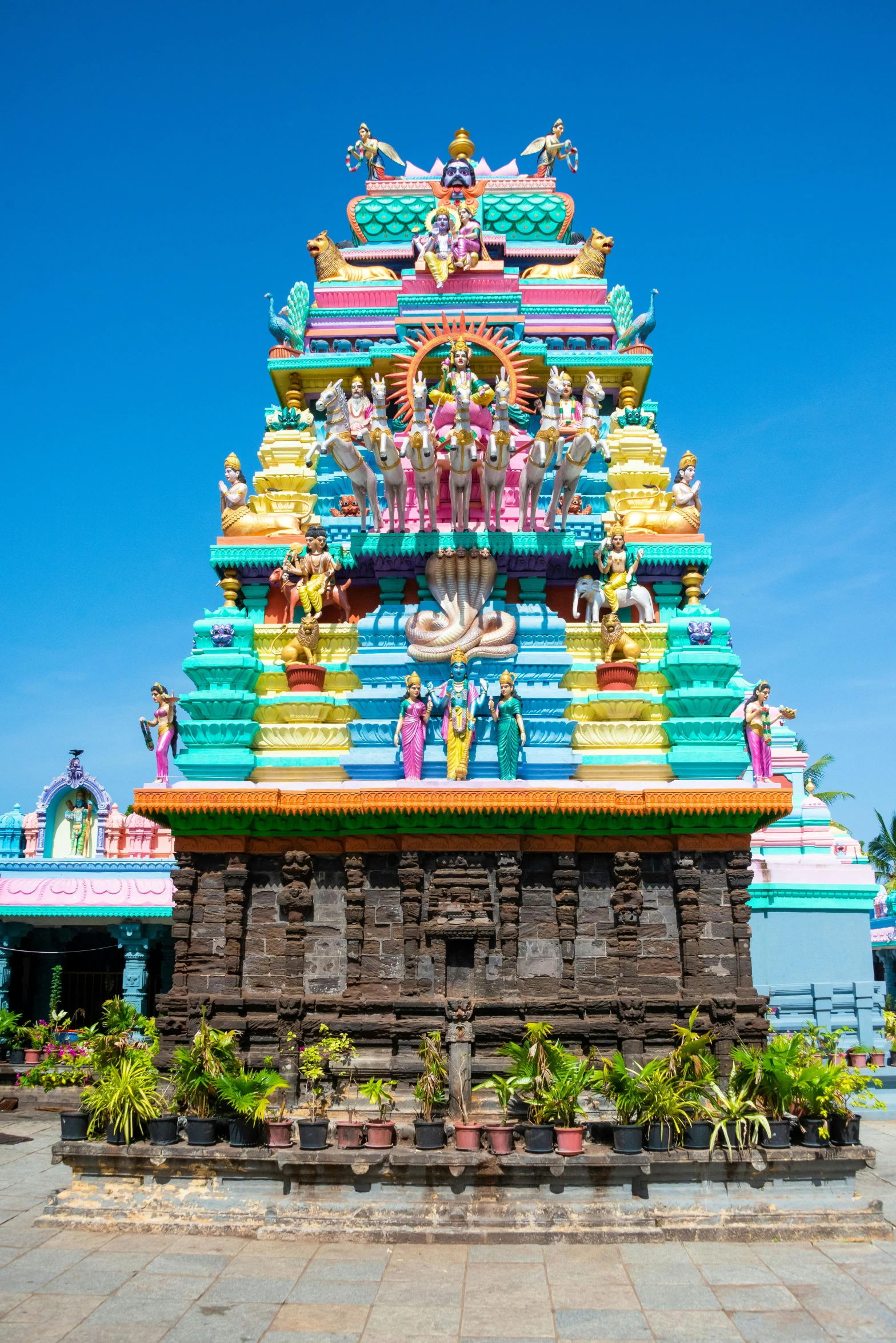 a tall colorful temple that has statues on it