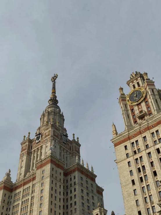 a large clock tower is in the center of two buildings