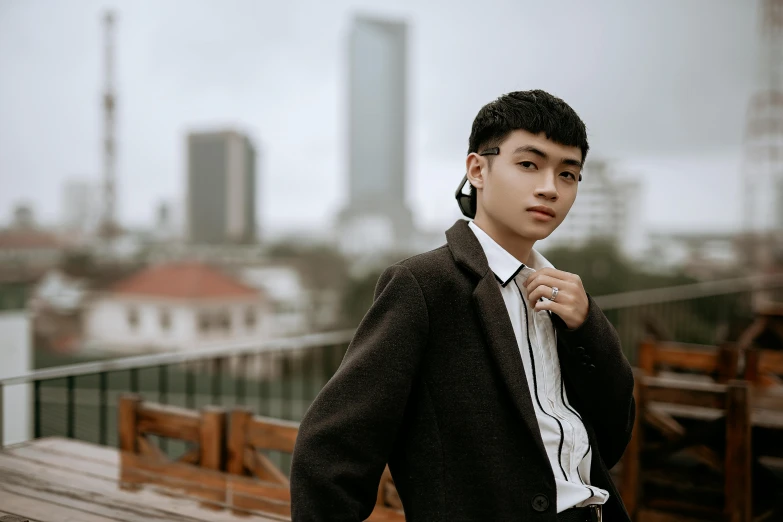 a young man that is standing on the bridge