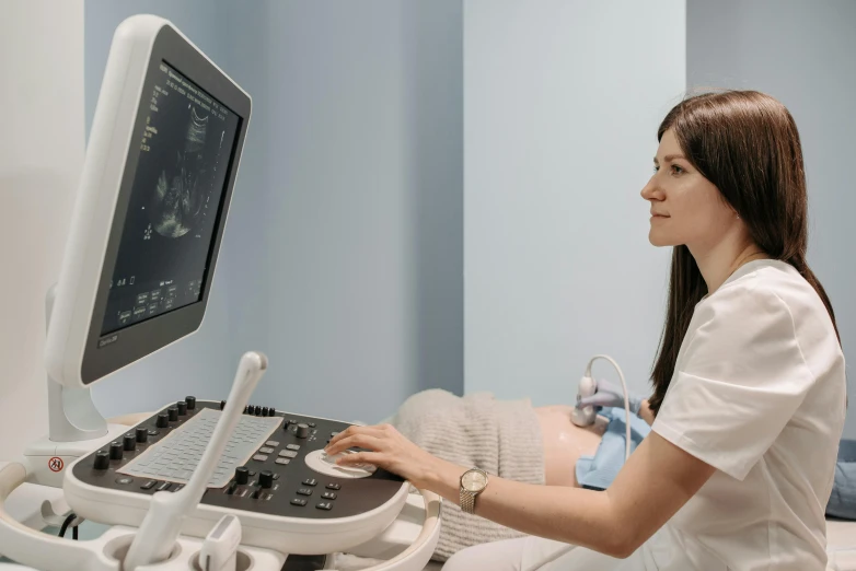 a woman sitting in front of a computer monitor