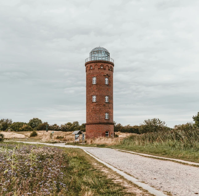 a tall brick tower on top of a hill