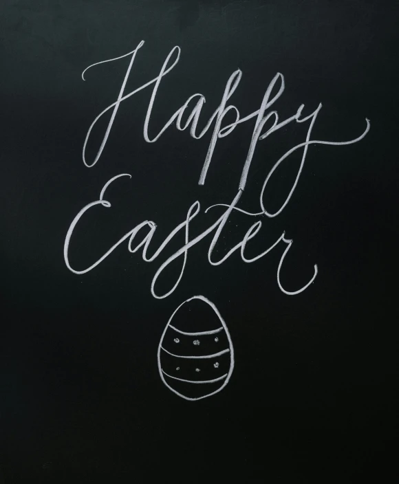 a chalk drawing is on a chalk board and says happy easter