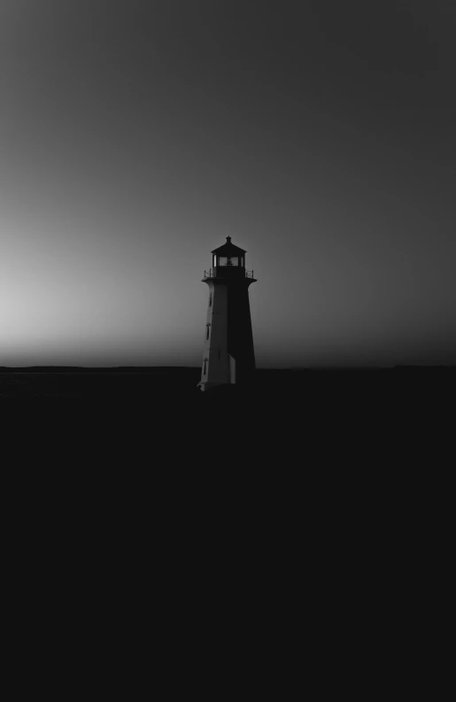 a black and white po of a light house in the dark