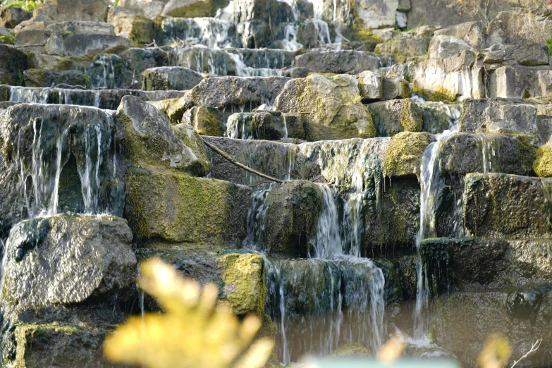 a close up of a fountain surrounded by rocks