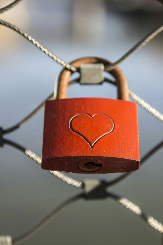 a locked padlock is adorned with a heart