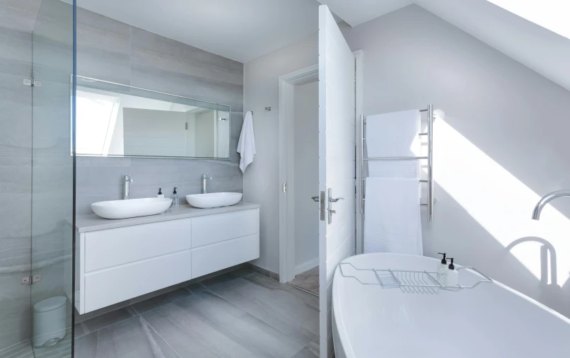 a nice and clean white bathroom with a large tub