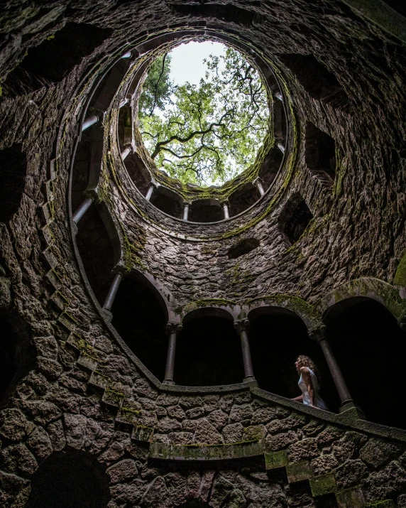 a stone structure with a circular window and people inside