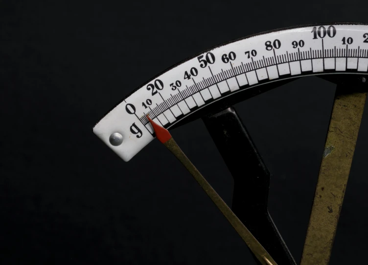 a measuring tool on a black surface with numbers