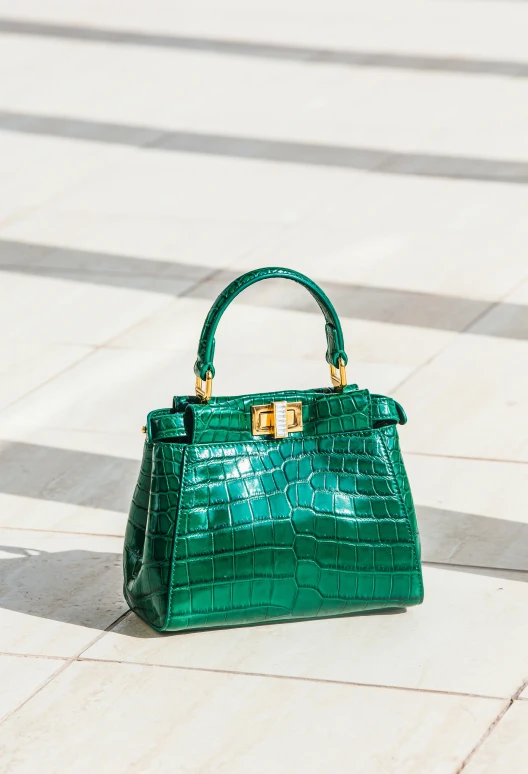 a green handbag is placed on the ground