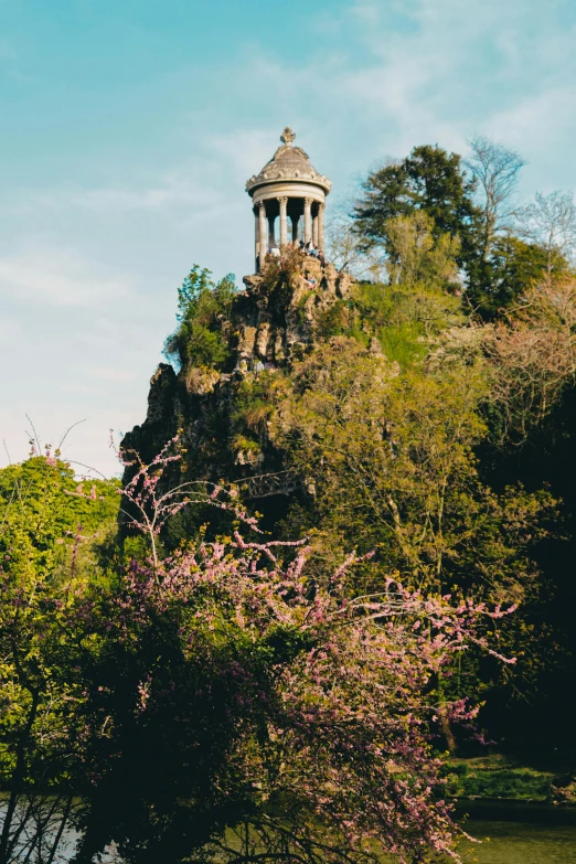 a bell tower on top of a steeple in a forest