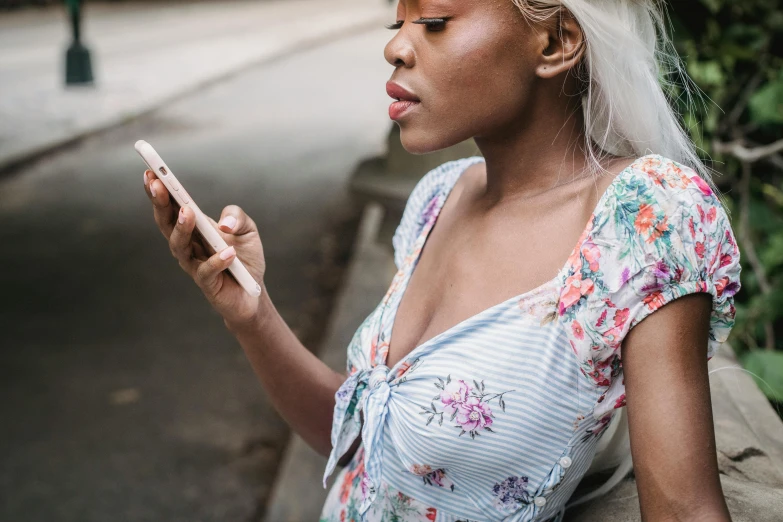 a woman looking at her cell phone on a city street