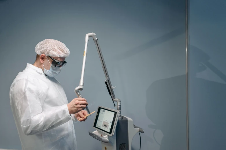 a man wearing a protective gear looking at a laptop