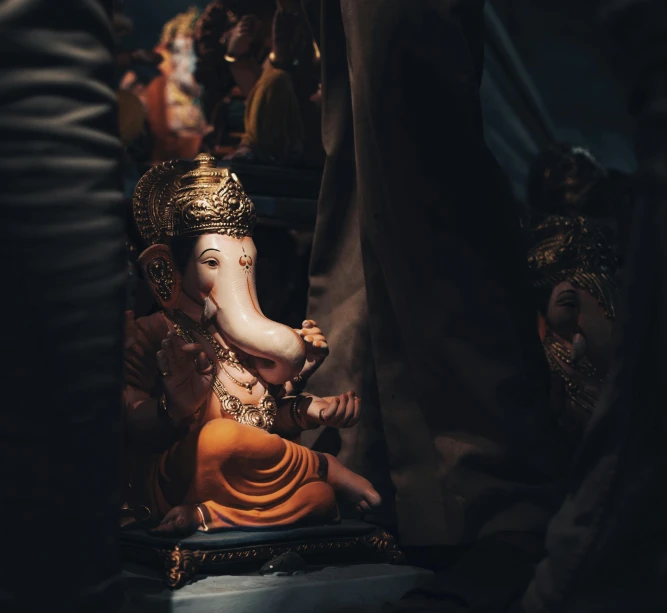 a close up of an elephant statue sitting on its side