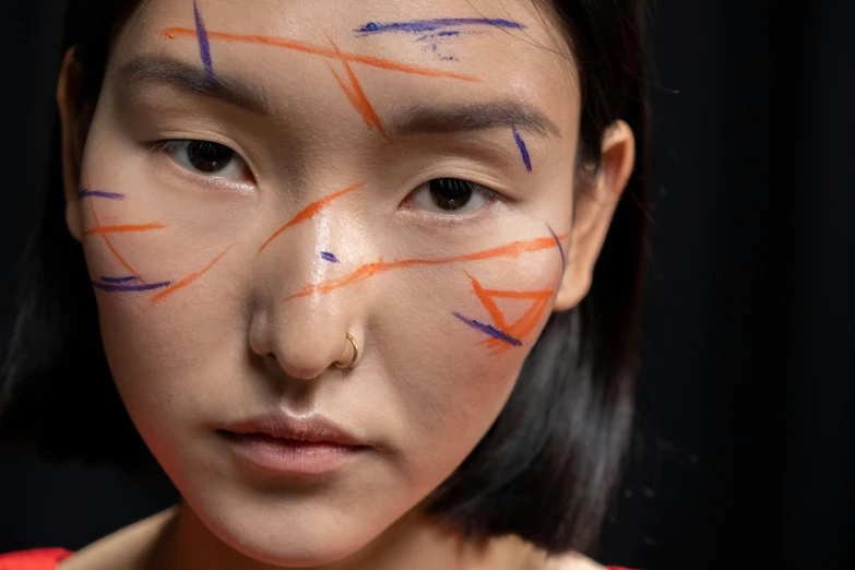 a girl with lines painted on her face and nose