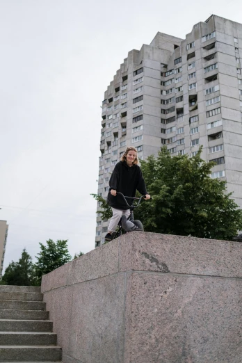 man skate boarding in front of a very tall building