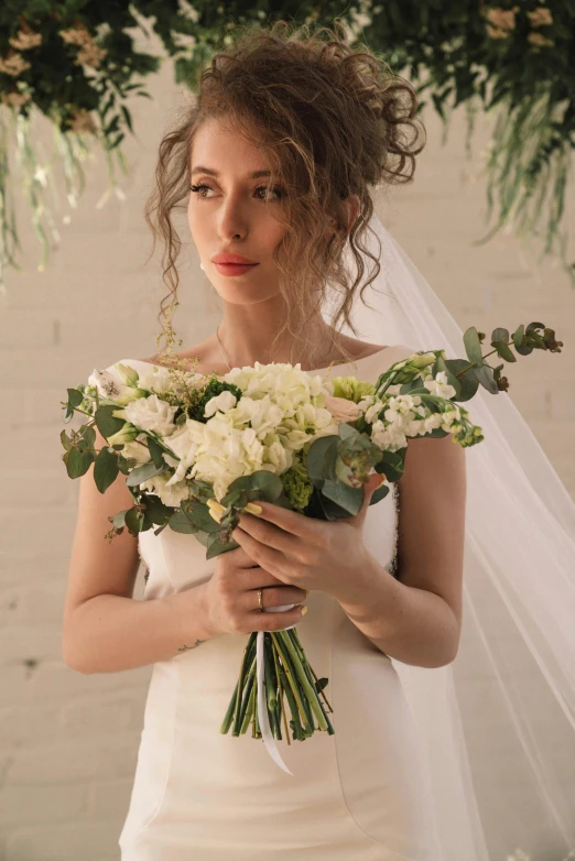 a beautiful woman is holding some white flowers