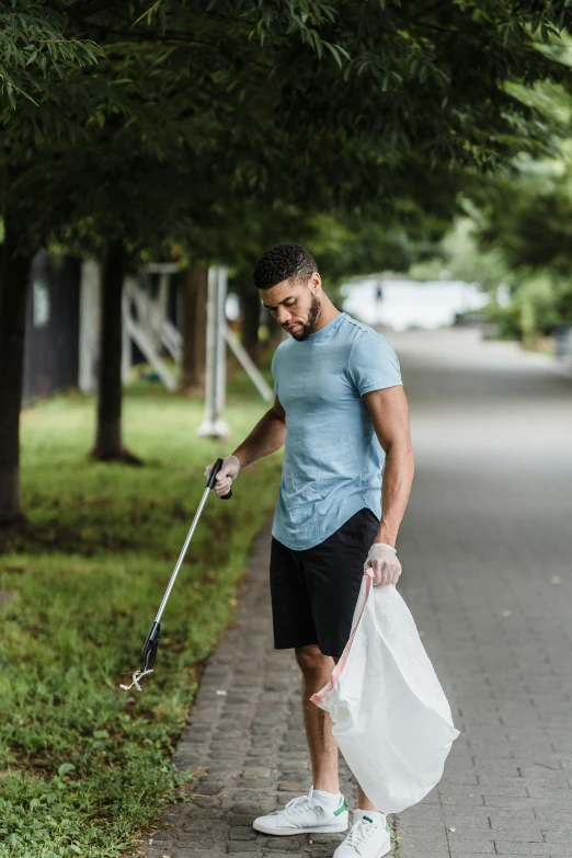 the man is holding a bag and a baseball bat