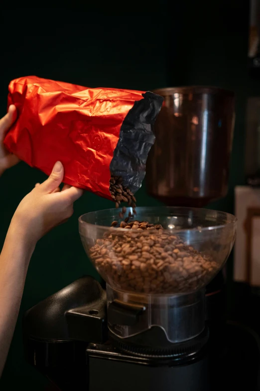 there is someone's hands pouring coffee into a bowl