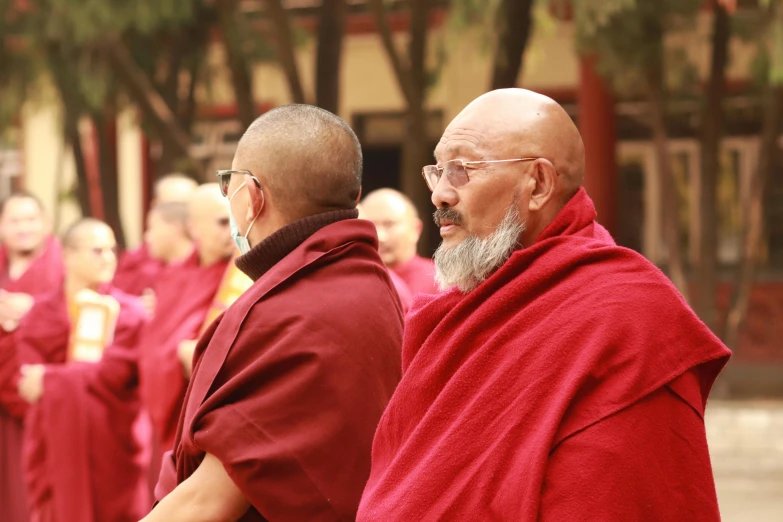 a group of people with monk robes standing around