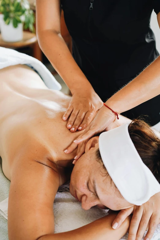 a woman getting a back massage in a salon