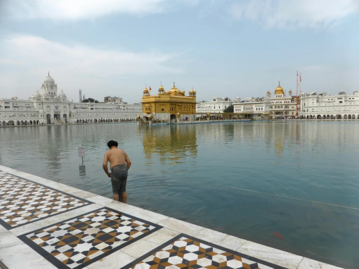 a man is standing in the middle of a lake