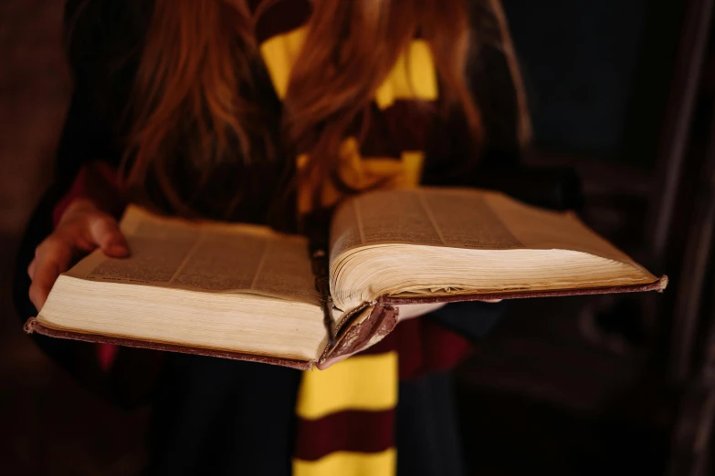 a woman with her hands in the open pages of a book