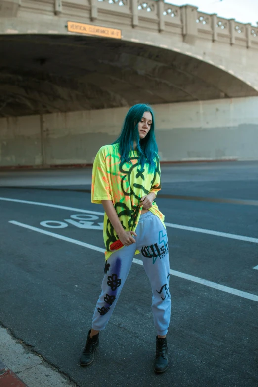 a woman with bright green hair standing in the street