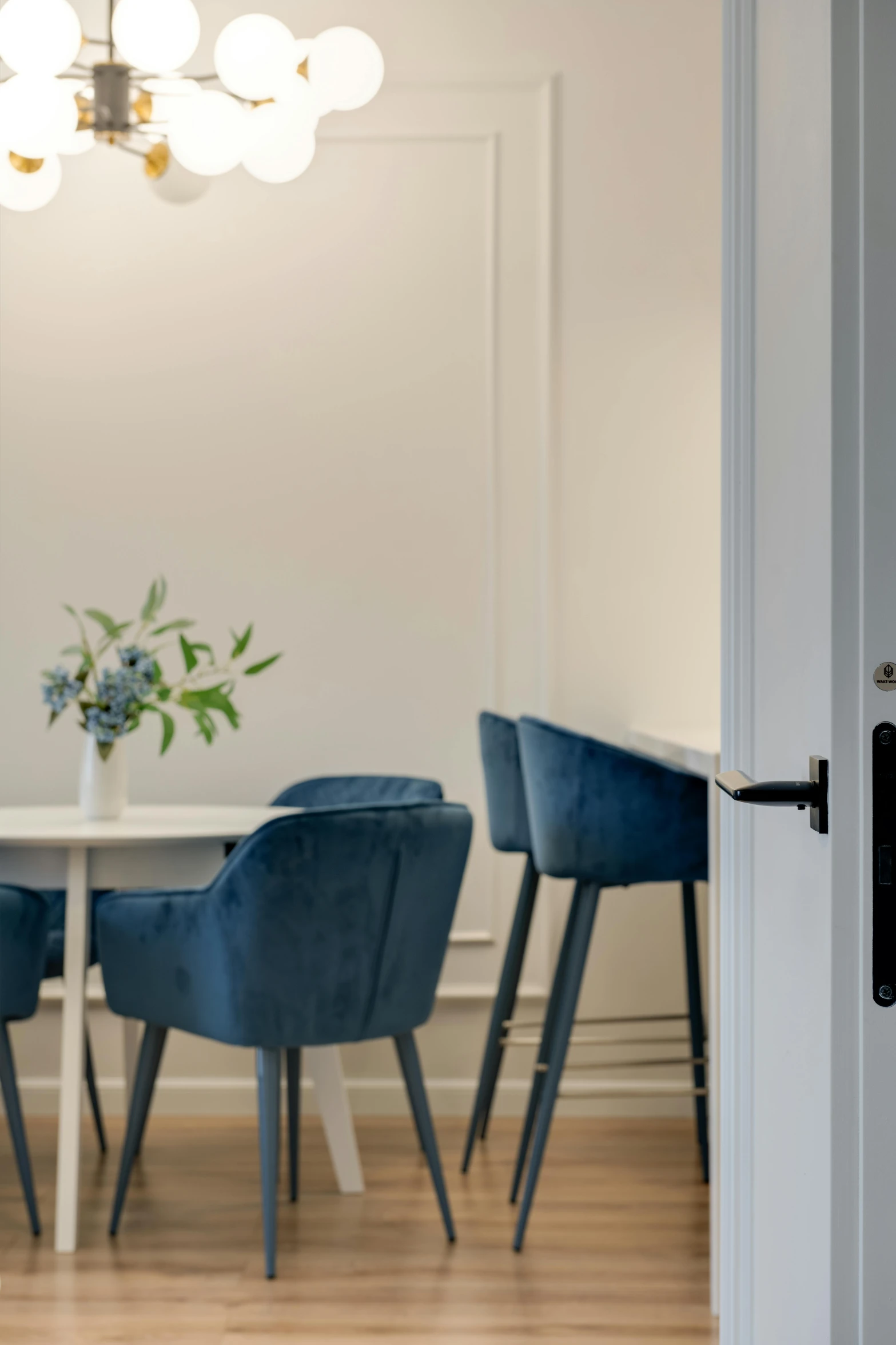 some blue chairs at a white table and a light